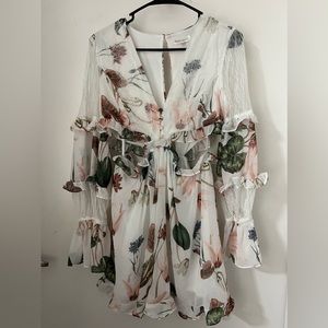 Size medium. Never worn! Dress/romper type outfit. Flowy perfect for spring.